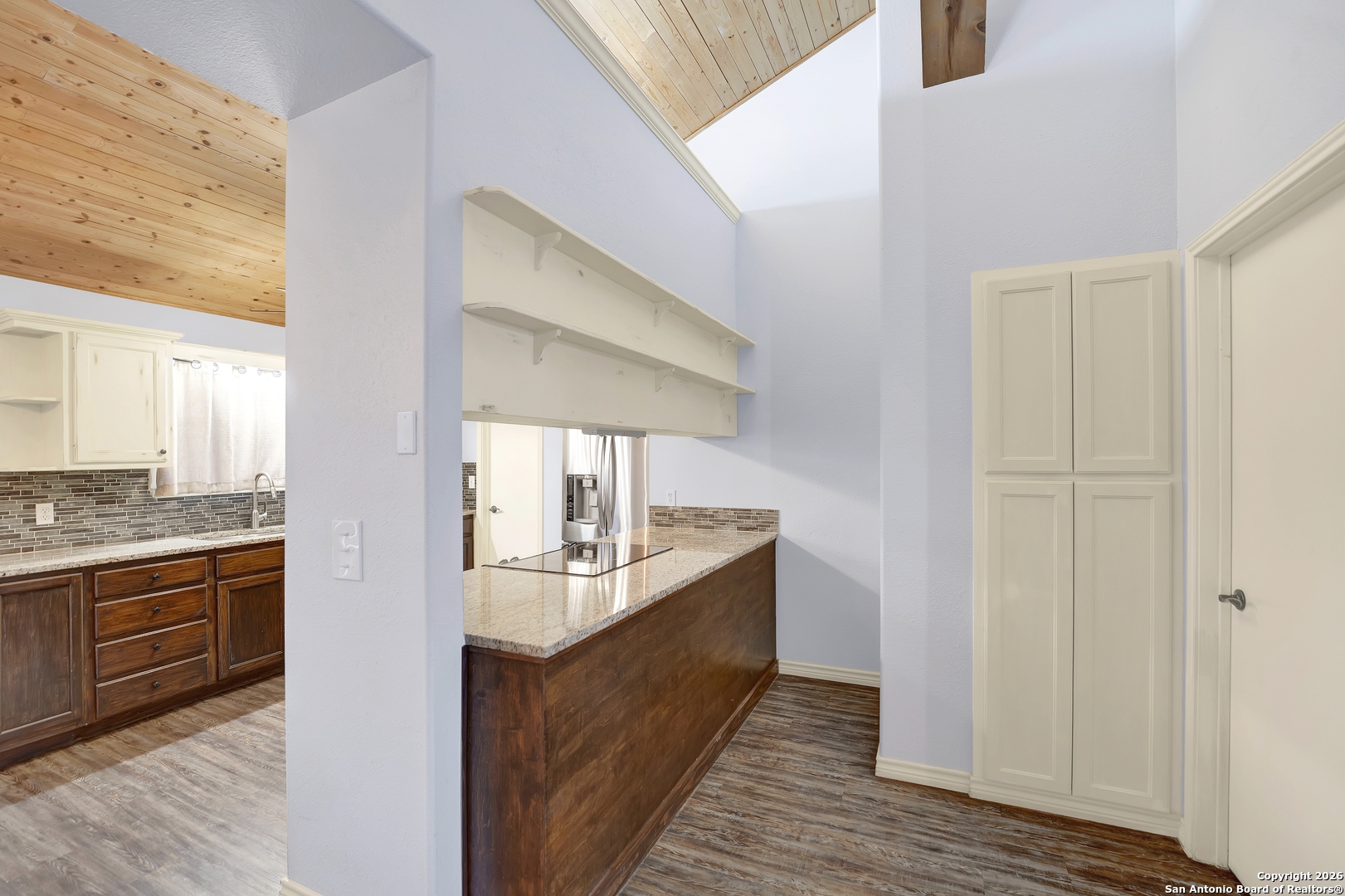 568 Firewheel Drive Bandera, TX 78003 - Photo 14 of 45 a large kitchen with a sink and dishwasher a stove with wooden floor