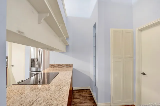 a view of kitchen with sink and refrigerator