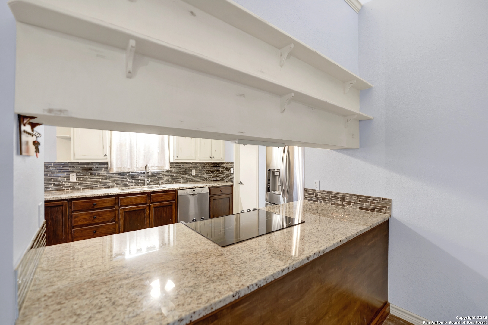 568 Firewheel Drive Bandera, TX 78003 - Photo 16 of 45 a kitchen with stainless steel appliances granite countertop a sink a stove counter space and cabinets