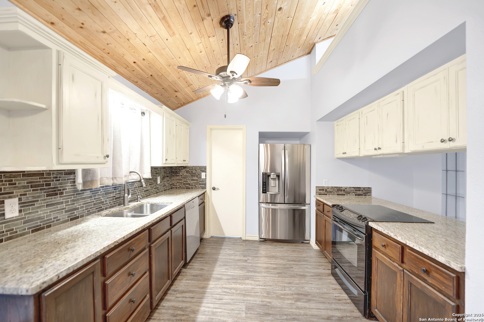 568 Firewheel Drive Bandera, TX 78003 - Photo 18 of 45 a kitchen with stainless steel appliances granite countertop a sink and a refrigerator