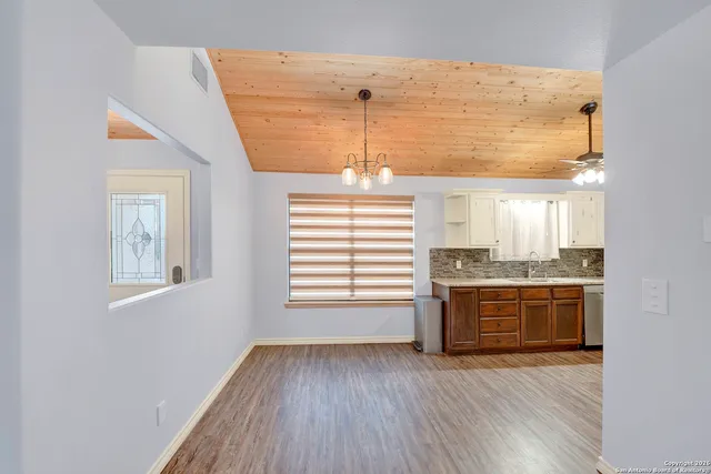 a view of kitchen and kitchen with granite countertop a stove top oven