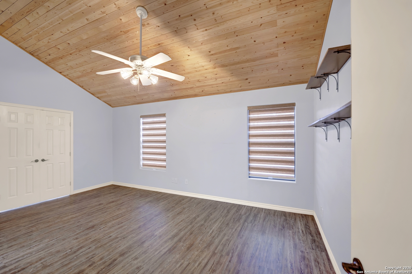568 Firewheel Drive Bandera, TX 78003 - Photo 23 of 45 wooden floor in an empty room with a window