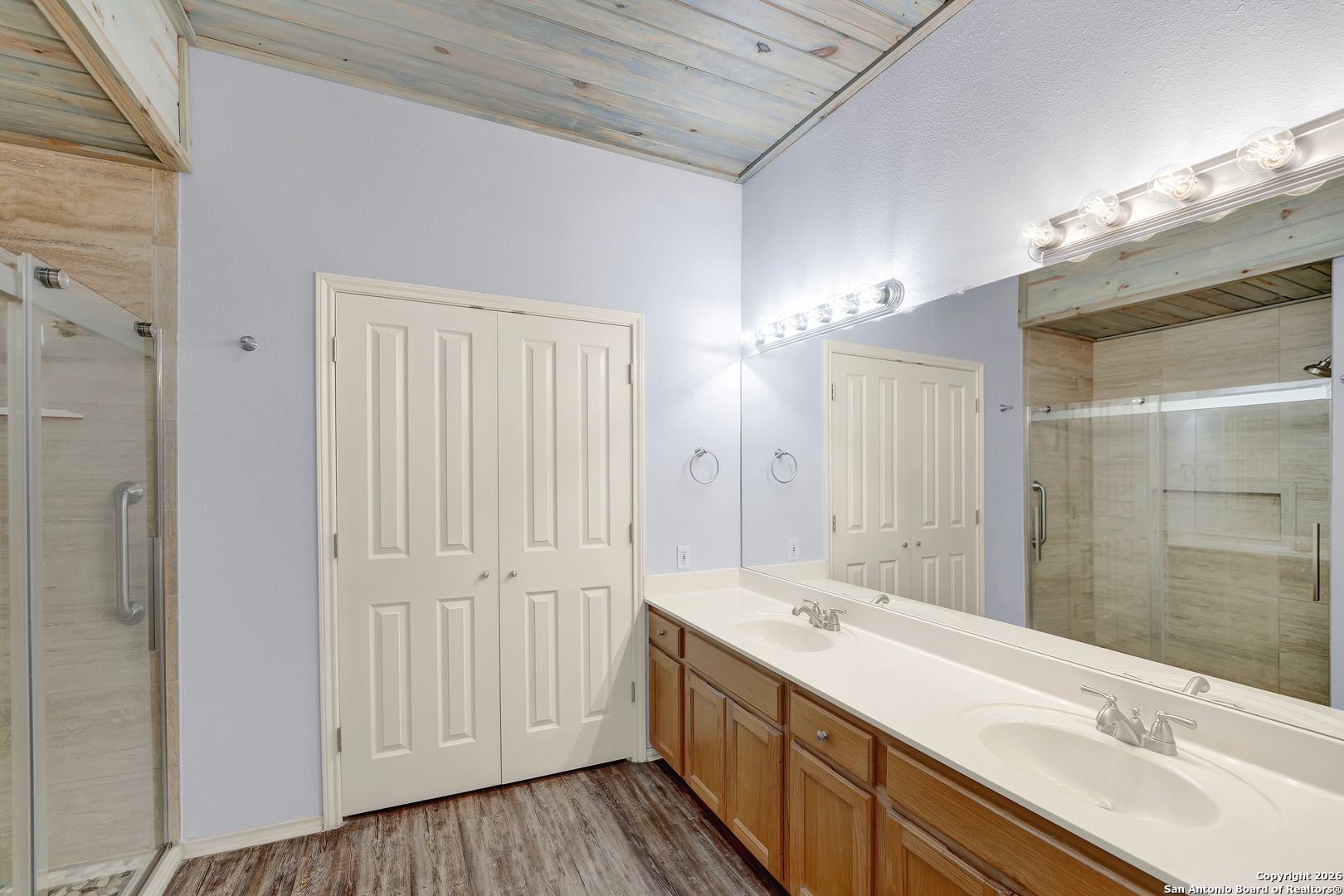 568 Firewheel Drive Bandera, TX 78003 - Photo 25 of 45 a bathroom with a double vanity sink and a mirror