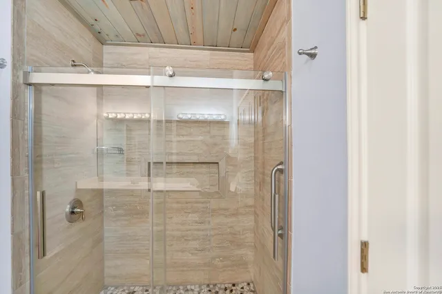 a bathroom with a glass shower door