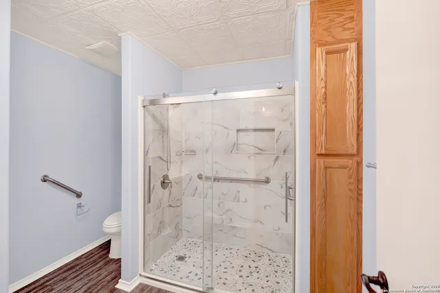 a bathroom with a glass shower door