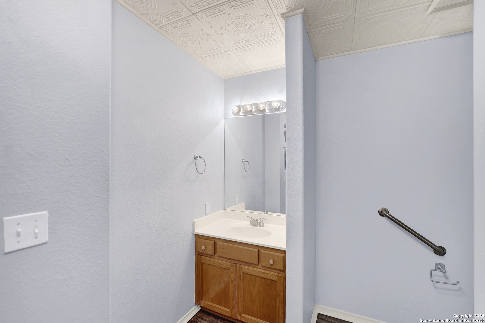 568 Firewheel Drive Bandera, TX 78003 - Photo 33 of 45 a bathroom with a sink and a mirror