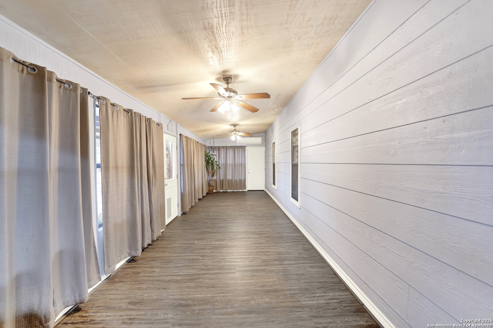 568 Firewheel Drive Bandera, TX 78003 - Photo 34 of 45 a view of a hallway with wooden floor