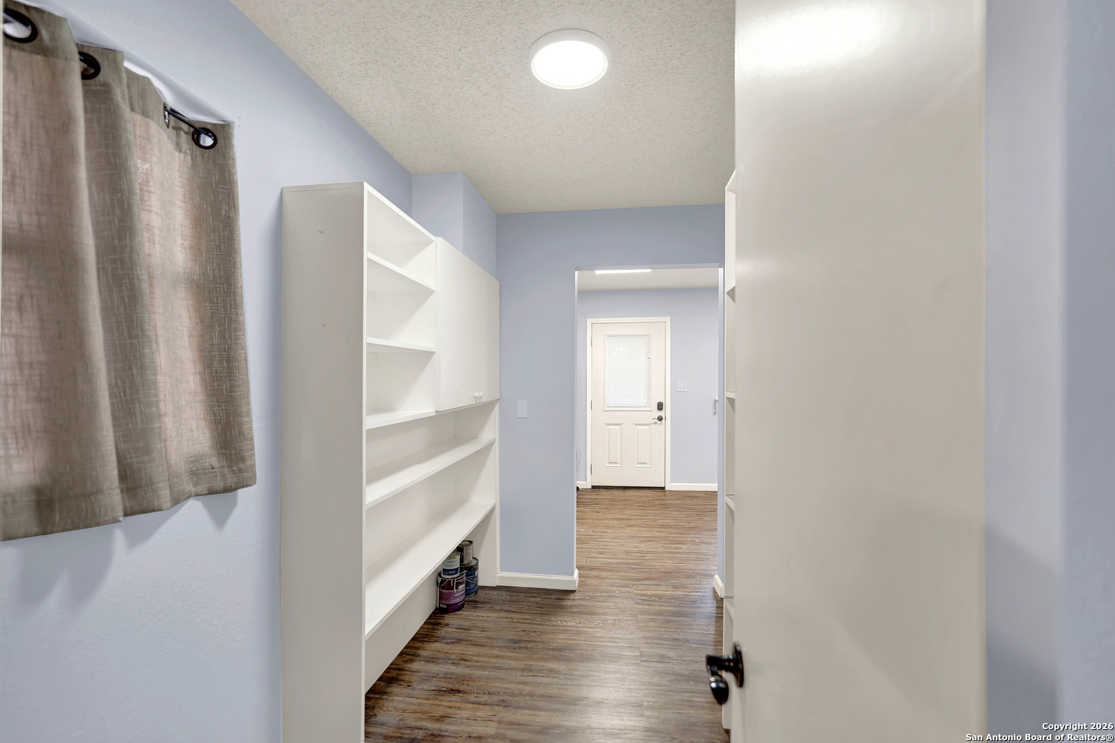568 Firewheel Drive Bandera, TX 78003 - Photo 35 of 45 a view of a hallway with wooden floor and staircase