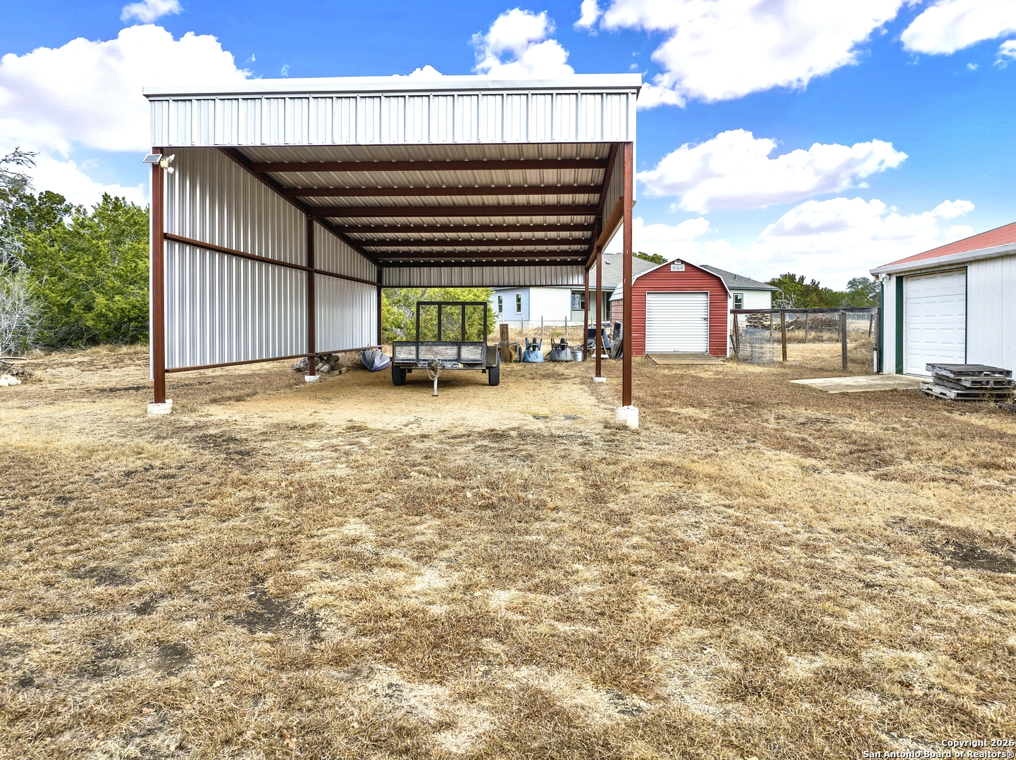568 Firewheel Drive Bandera, TX 78003 - Photo 39 of 45 a view of a house with backyard and sitting area