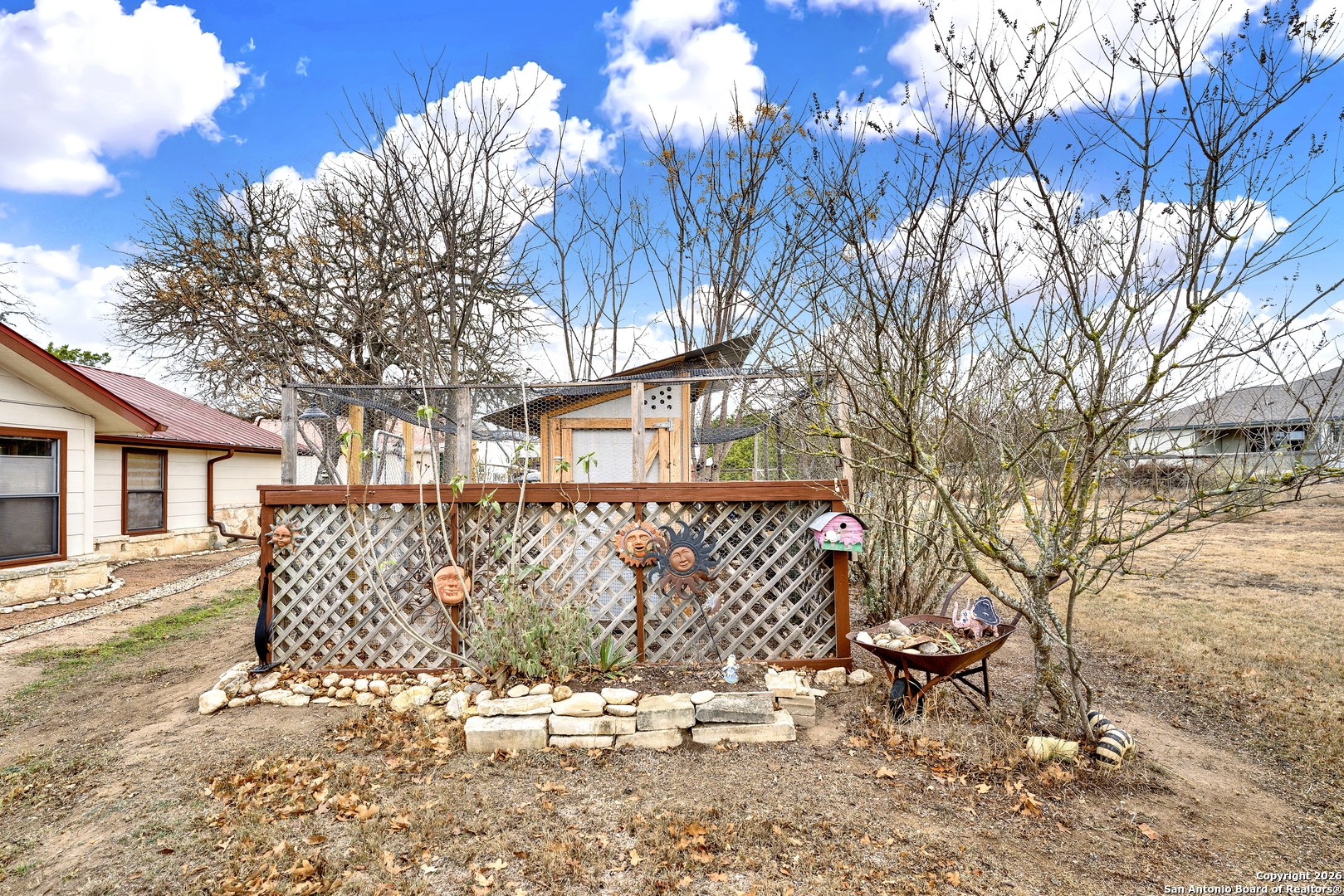 568 Firewheel Drive Bandera, TX 78003 - Photo 44 of 45 a wooden bench sitting in front of a house