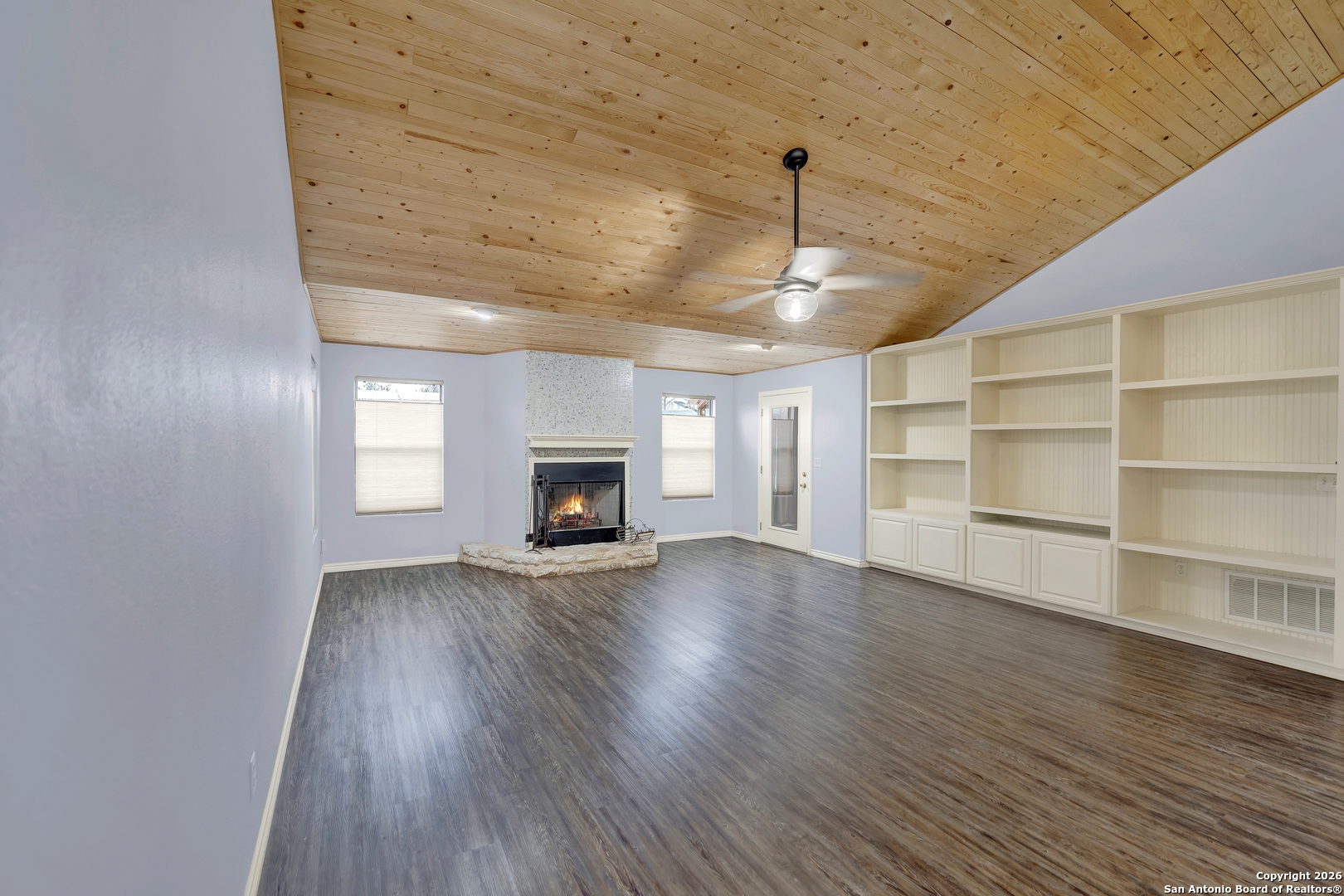 568 Firewheel Drive Bandera, TX 78003 - Photo 10 of 45 a view of an empty room with a fireplace and a window