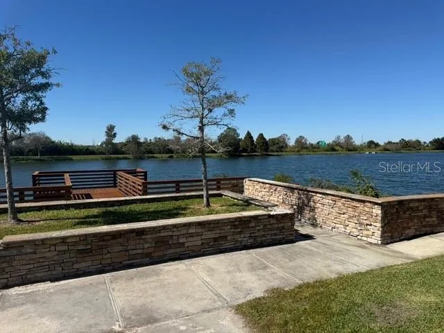 a view of swimming pool with outdoor seating and plants