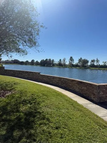 a view of a lake with houses in the back