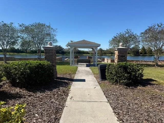a view of a pathway with a garden