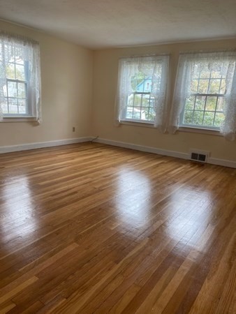 45 Harvard Road Shirley, MA 01464 - Photo 17 of 37 an empty room with wooden floor and windows