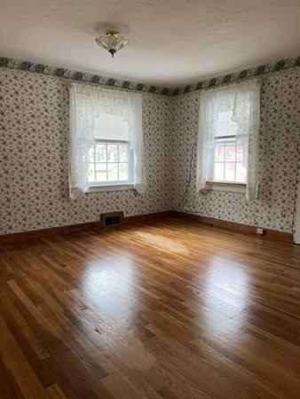 45 Harvard Road Shirley, MA 01464 - Photo 19 of 37 an empty room with wooden floor and windows