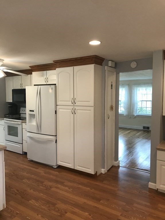 45 Harvard Road Shirley, MA 01464 - Photo 9 of 37 a view of a kitchen with wooden floor and electronic appliances
