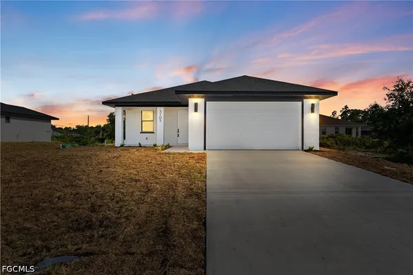 a front view of a house with a yard and garage