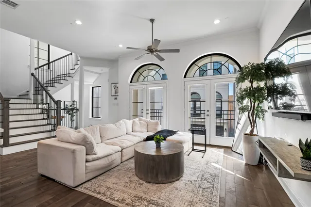 a living room with furniture a chandelier a rug and a window