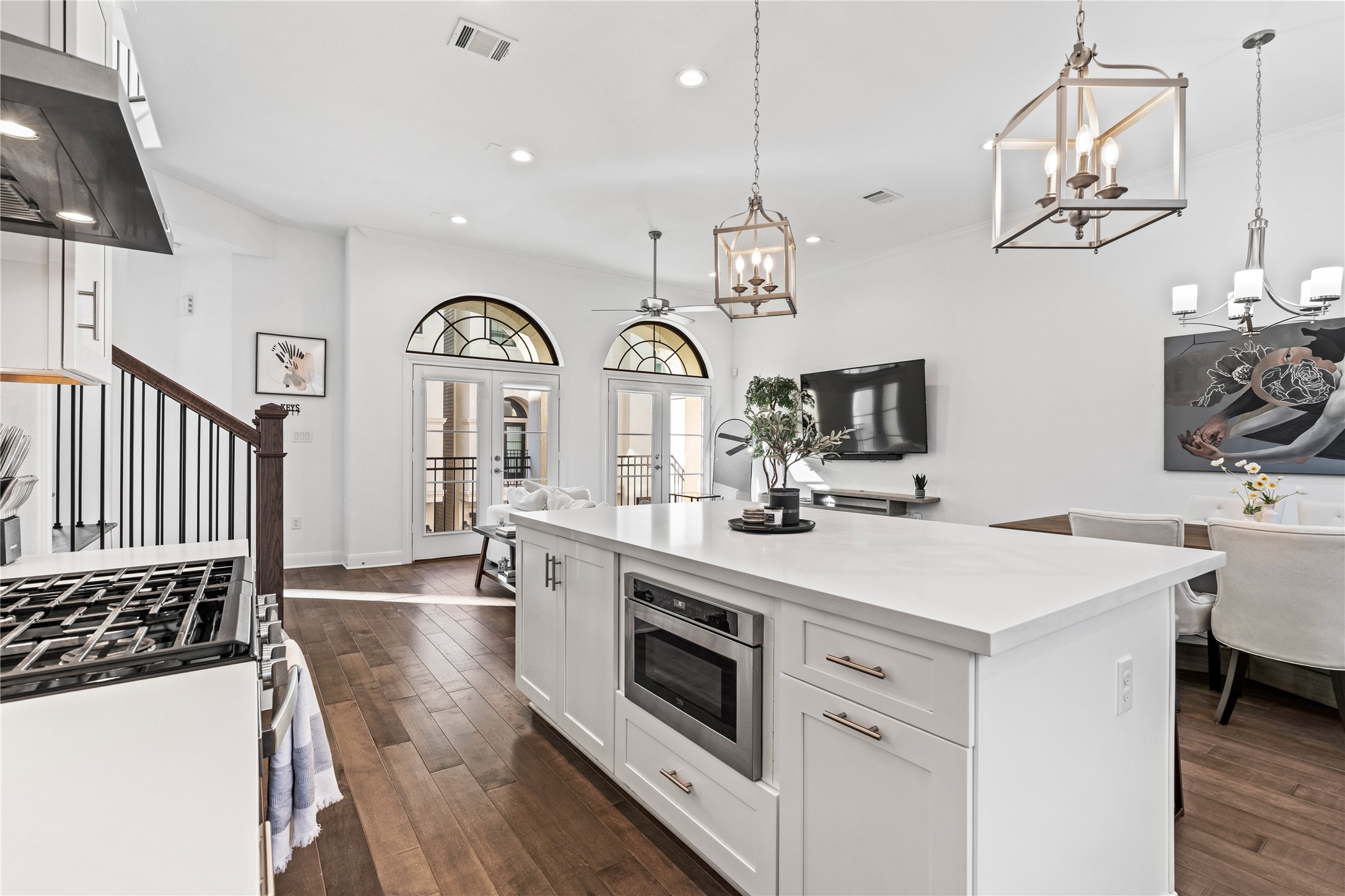 3319 Beverly Forest Drive Houston, TX 77057 - Photo 12 of 32 a kitchen with a sink dishwasher a stove and a dining table with wooden floor