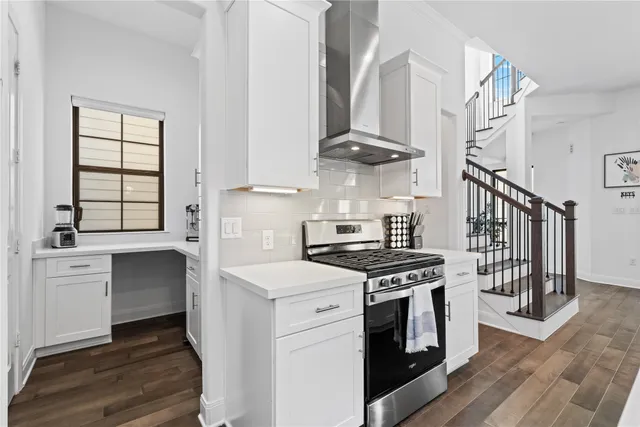 a kitchen with stainless steel appliances a stove a sink and cabinets