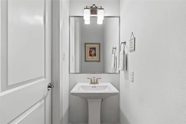 a bathroom with a sink and mirror