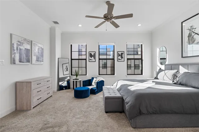 a bedroom with a large bed and a chandelier
