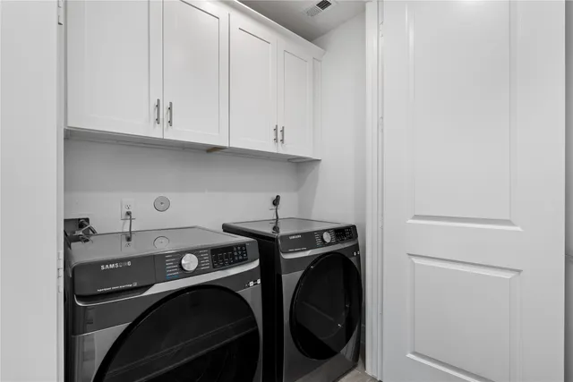 a view of a storage and utility room with washer and dryer