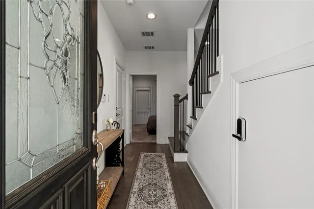 a hallway with a large mirror and a wooden floor