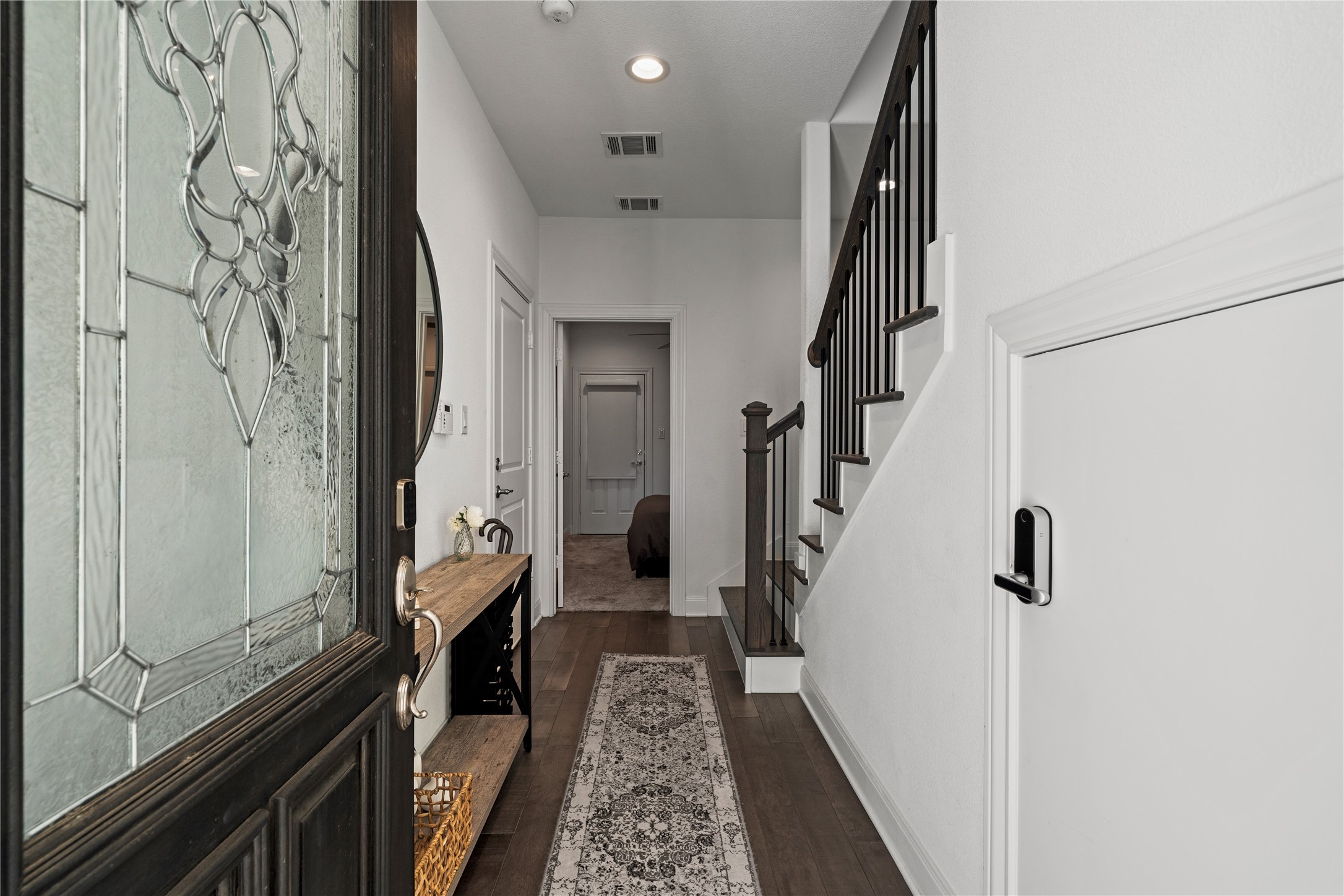 3319 Beverly Forest Drive Houston, TX 77057 - Photo 3 of 32 a hallway with a large mirror and a wooden floor