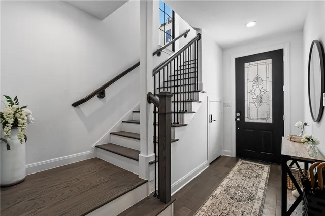 a view of entryway and hall with wooden floor