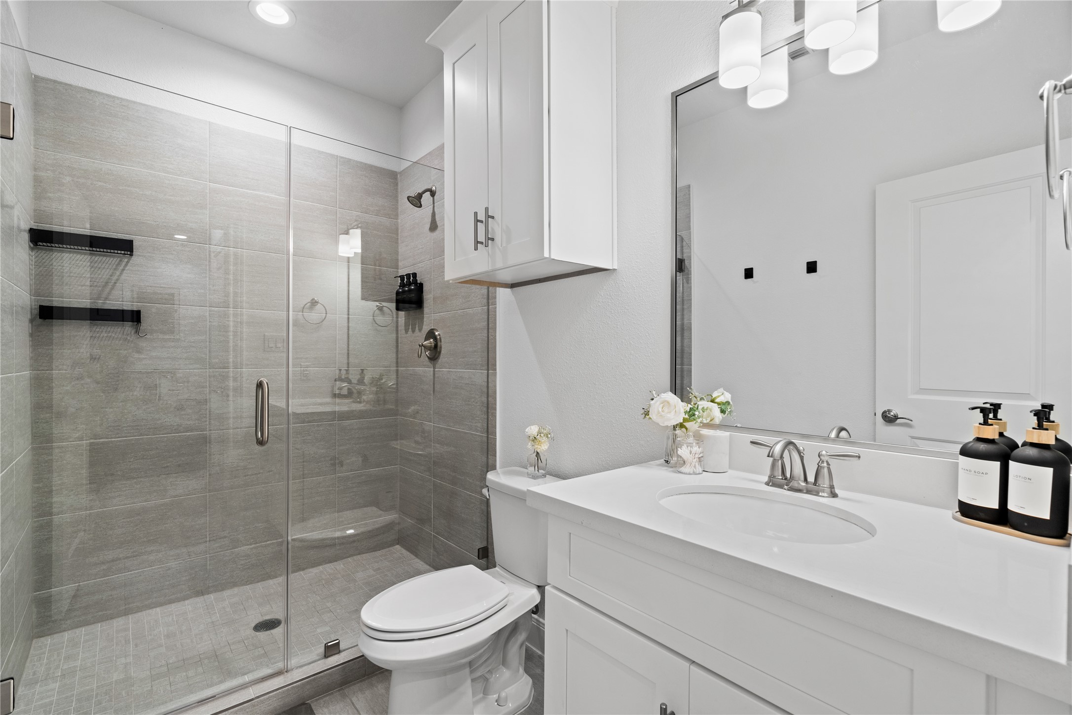 3319 Beverly Forest Drive Houston, TX 77057 - Photo 7 of 32 a bathroom with a granite countertop sink a toilet and shower