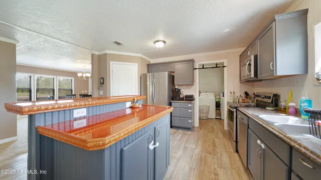 a kitchen with stainless steel appliances granite countertop sink stove top oven and refrigerator