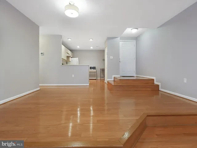 a view of an empty room with a kitchen