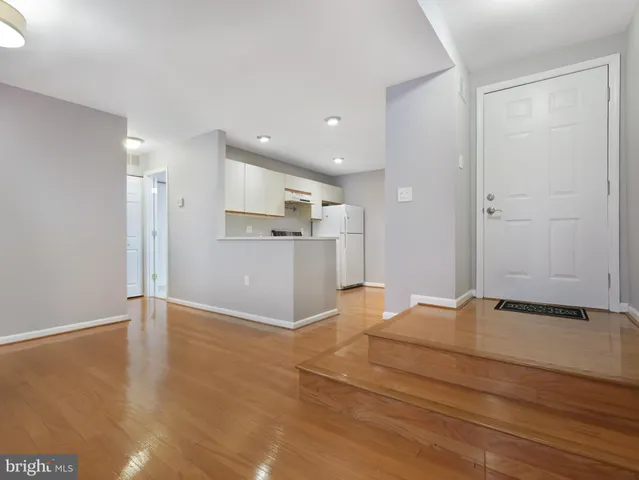 a bedroom with a bed and painting on the wall