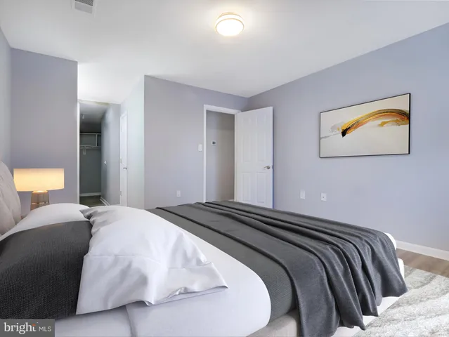 a bedroom with a large bed and a large window