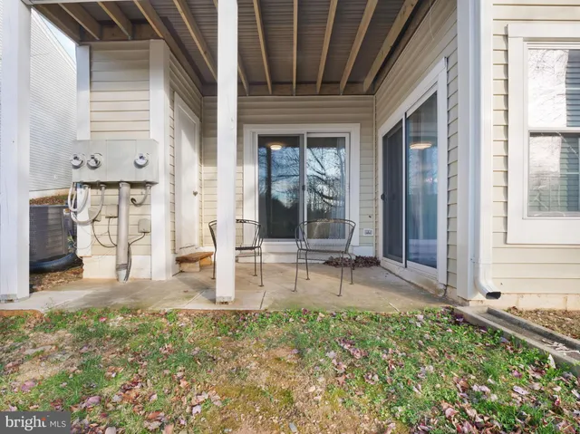 a kitchen with granite countertop a sink stainless steel appliances and furniture
