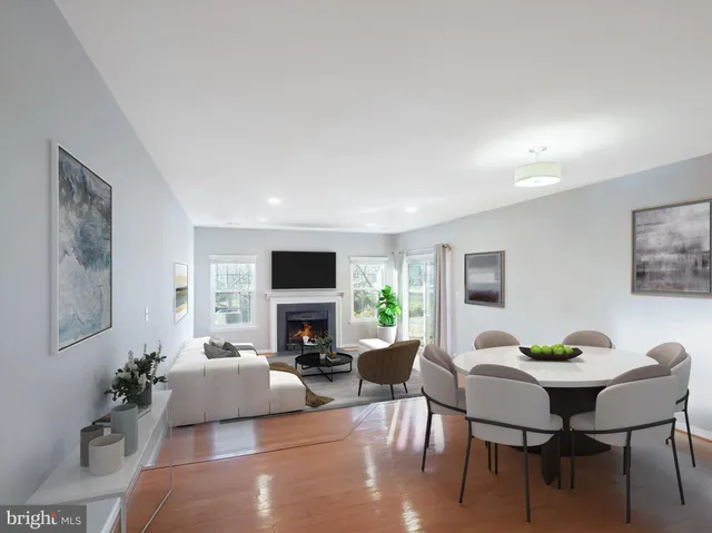 a living room with furniture flat screen tv and a large window