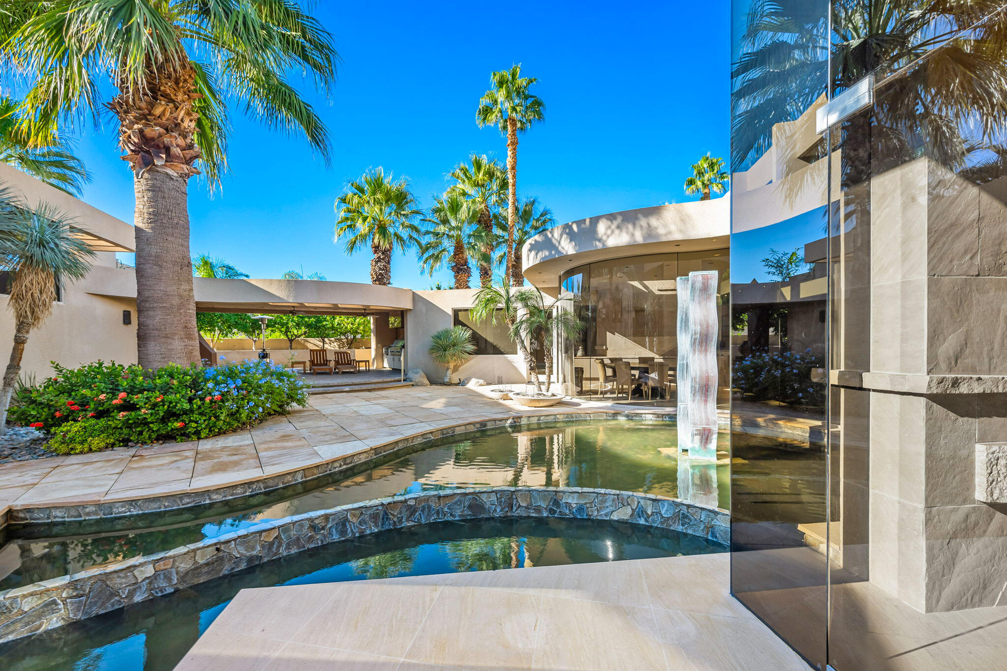 47725 Vintage Drive East Indian Wells, CA 92210 - Photo 2 of 10 a view of a swimming pool with potted plants