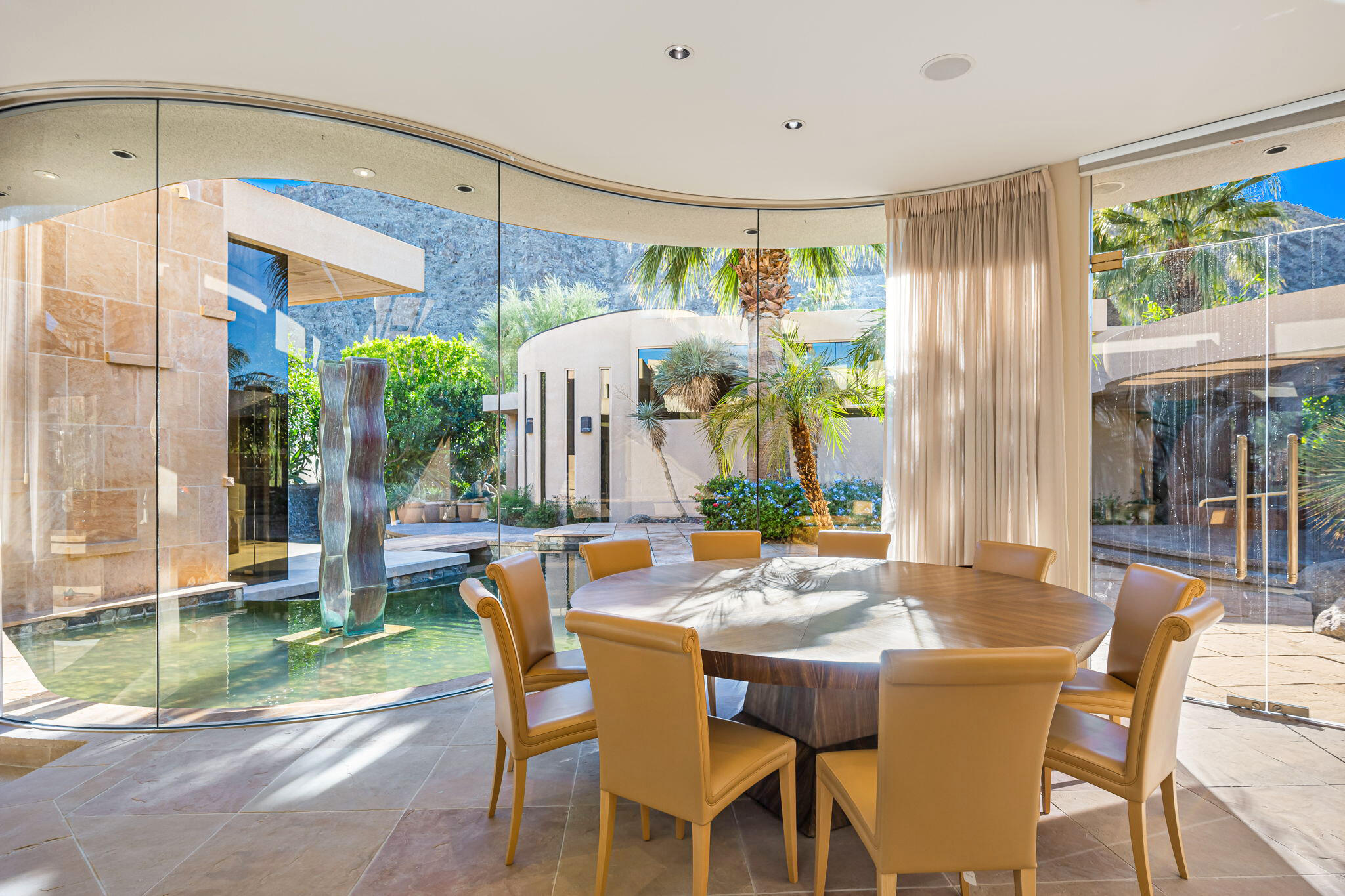 47725 Vintage Drive East Indian Wells, CA 92210 - Photo 3 of 10 a dining room with furniture a garden and outdoor view