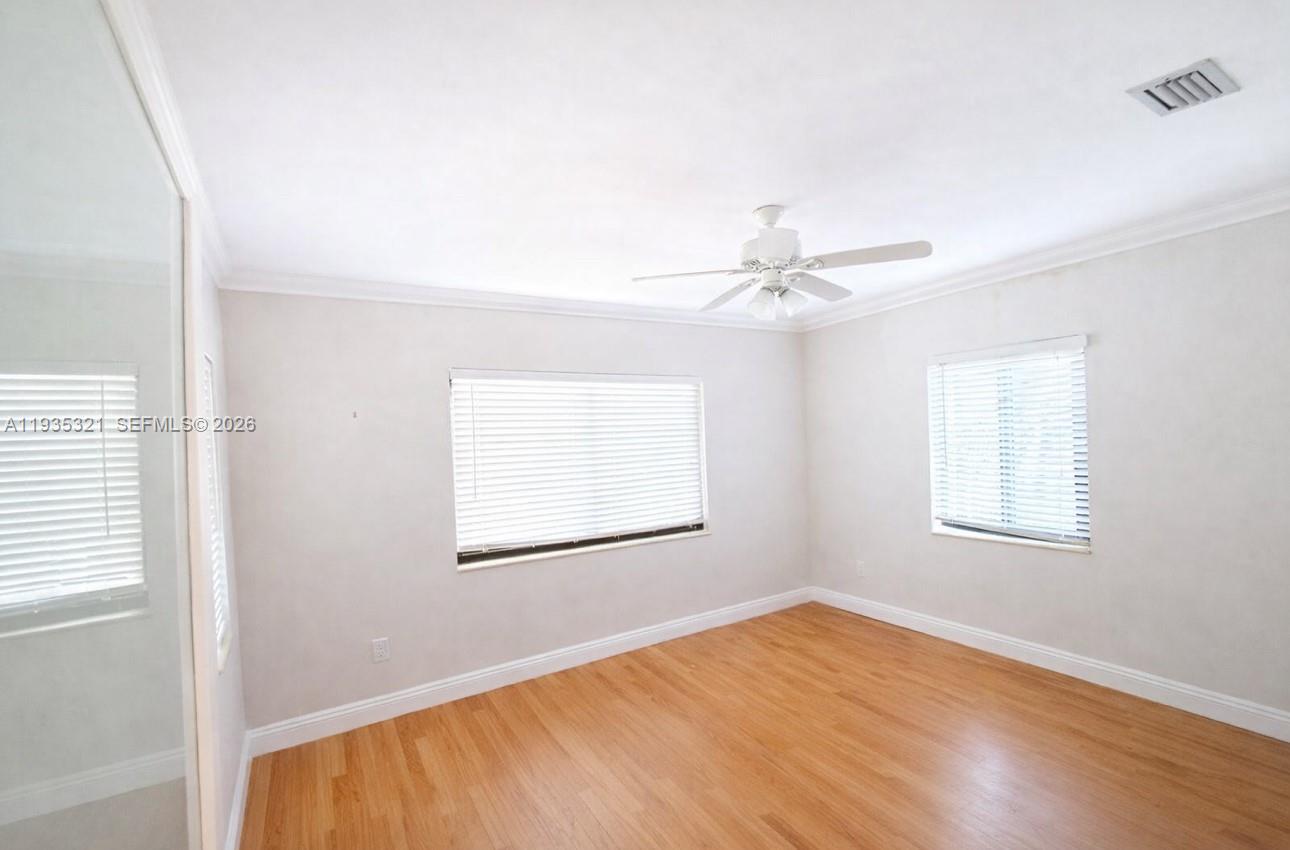 1780 Southwest 21st Street Miami, FL 33145 - Photo 6 of 17 an empty room with windows and fan