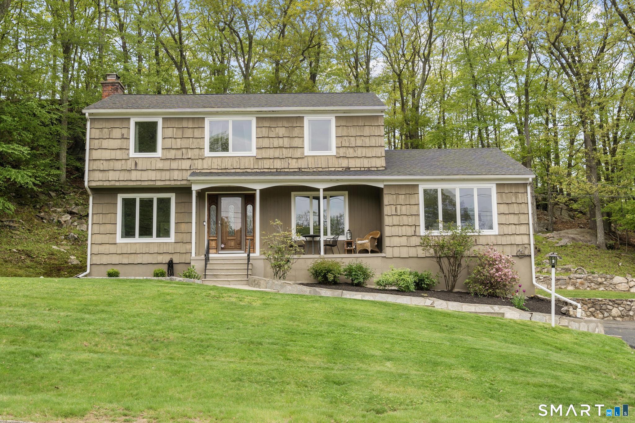 832 Quarter Mile Road Orange, CT 06477 - Photo 1 of 39 a front view of a house with a yard