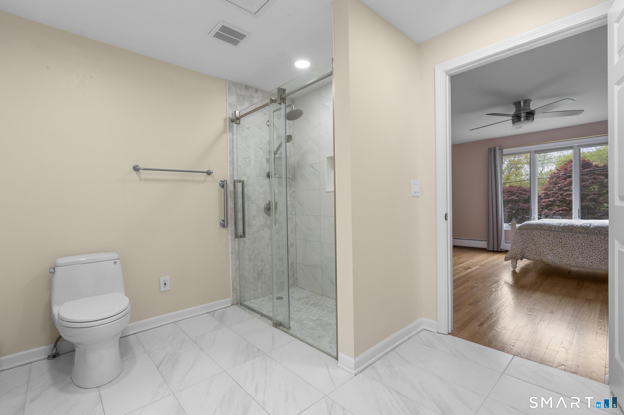 832 Quarter Mile Road Orange, CT 06477 - Photo 11 of 39 a bathroom with a toilet a sink and shower