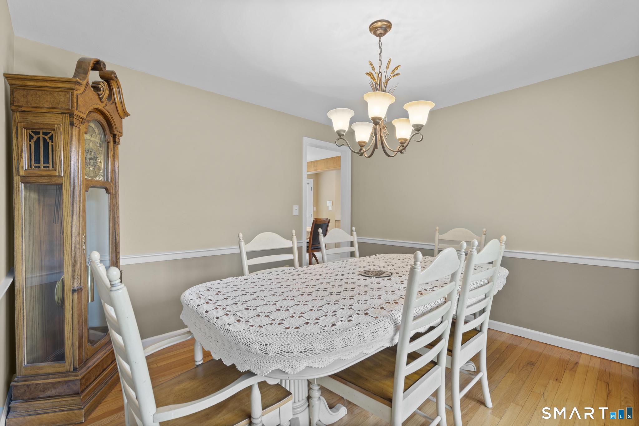 832 Quarter Mile Road Orange, CT 06477 - Photo 13 of 39 a view of a dining room with furniture and wooden floor