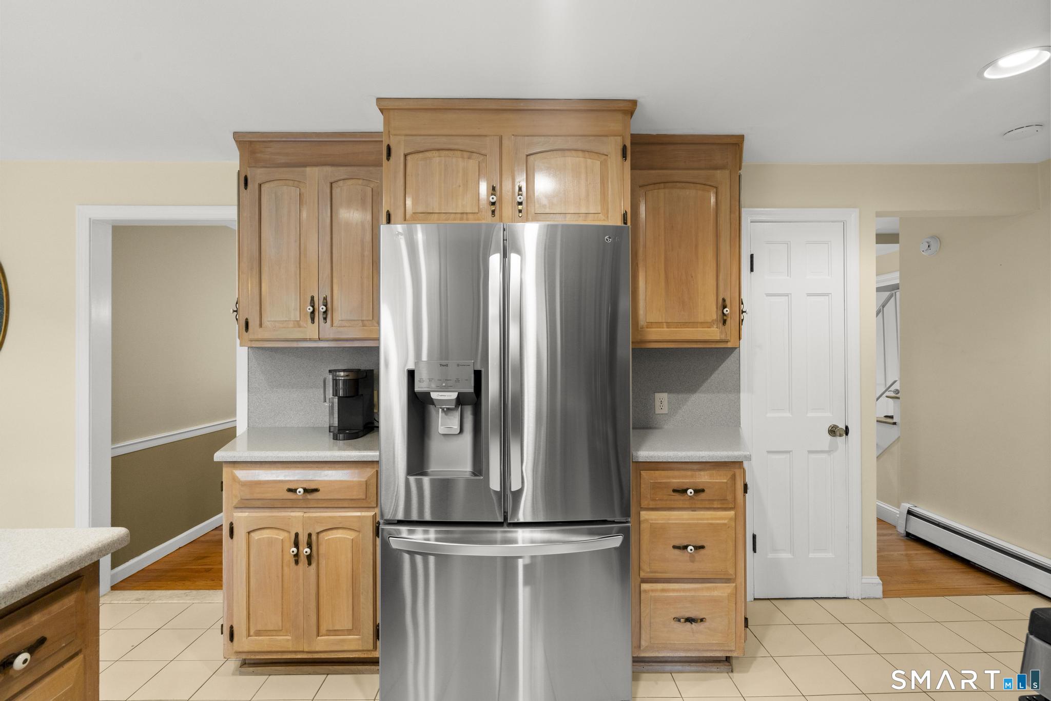 832 Quarter Mile Road Orange, CT 06477 - Photo 16 of 39 a kitchen with stainless steel appliances a refrigerator and cabinets