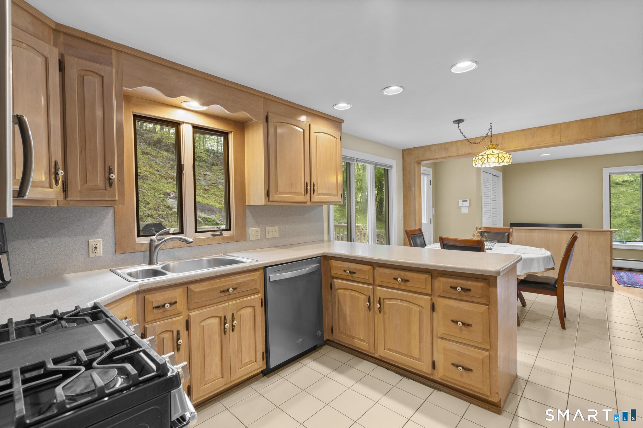 832 Quarter Mile Road Orange, CT 06477 - Photo 17 of 39 a kitchen with a stove a sink and a refrigerator