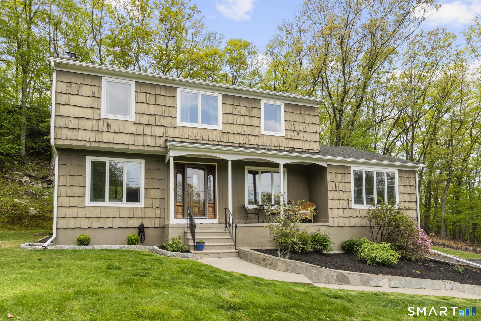 832 Quarter Mile Road Orange, CT 06477 - Photo 2 of 39 a front view of a house with a yard