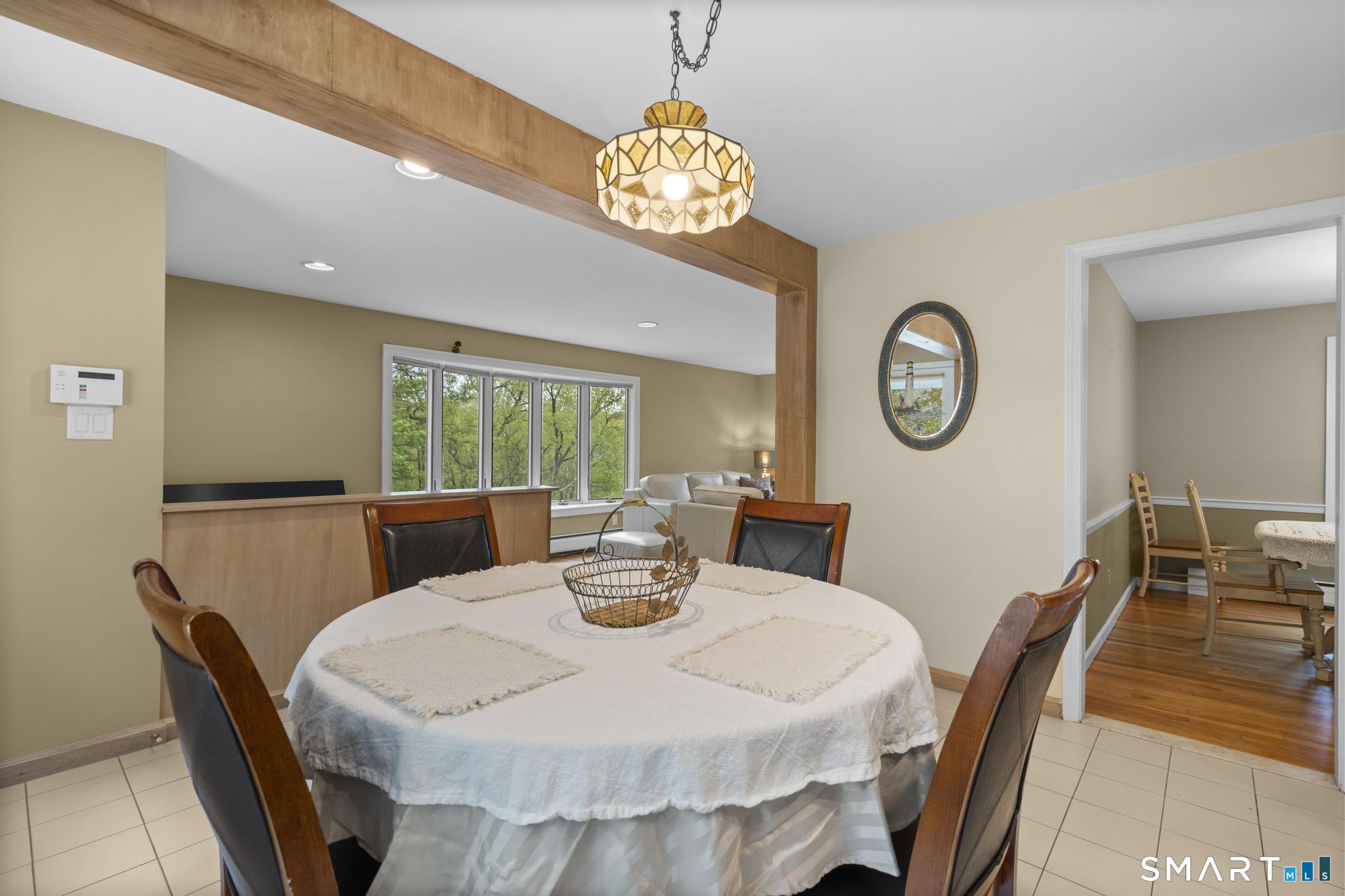 832 Quarter Mile Road Orange, CT 06477 - Photo 21 of 39 a view of a dining room with furniture window and outside view