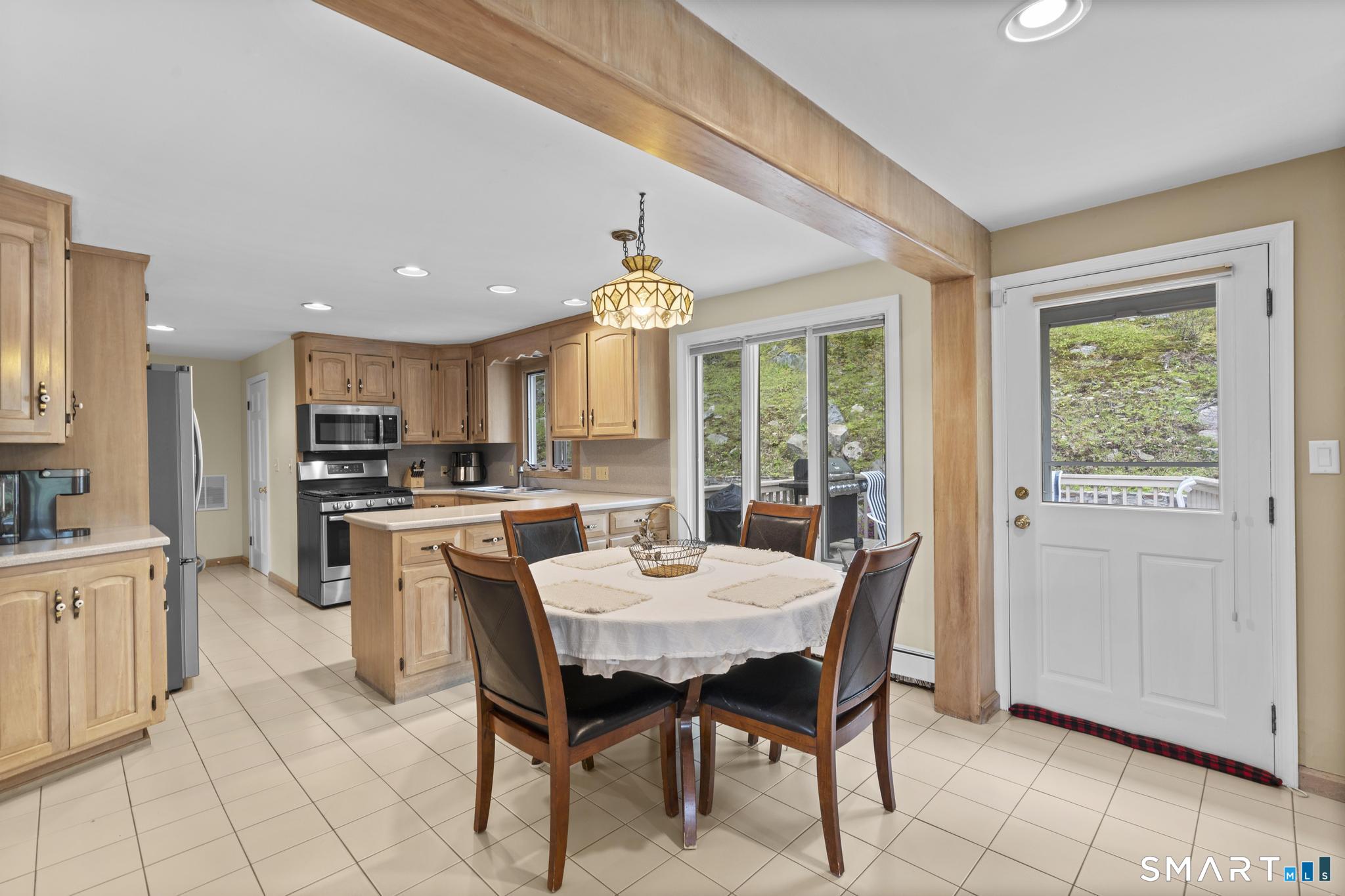 832 Quarter Mile Road Orange, CT 06477 - Photo 22 of 39 a view of a dining room with furniture window and outside view