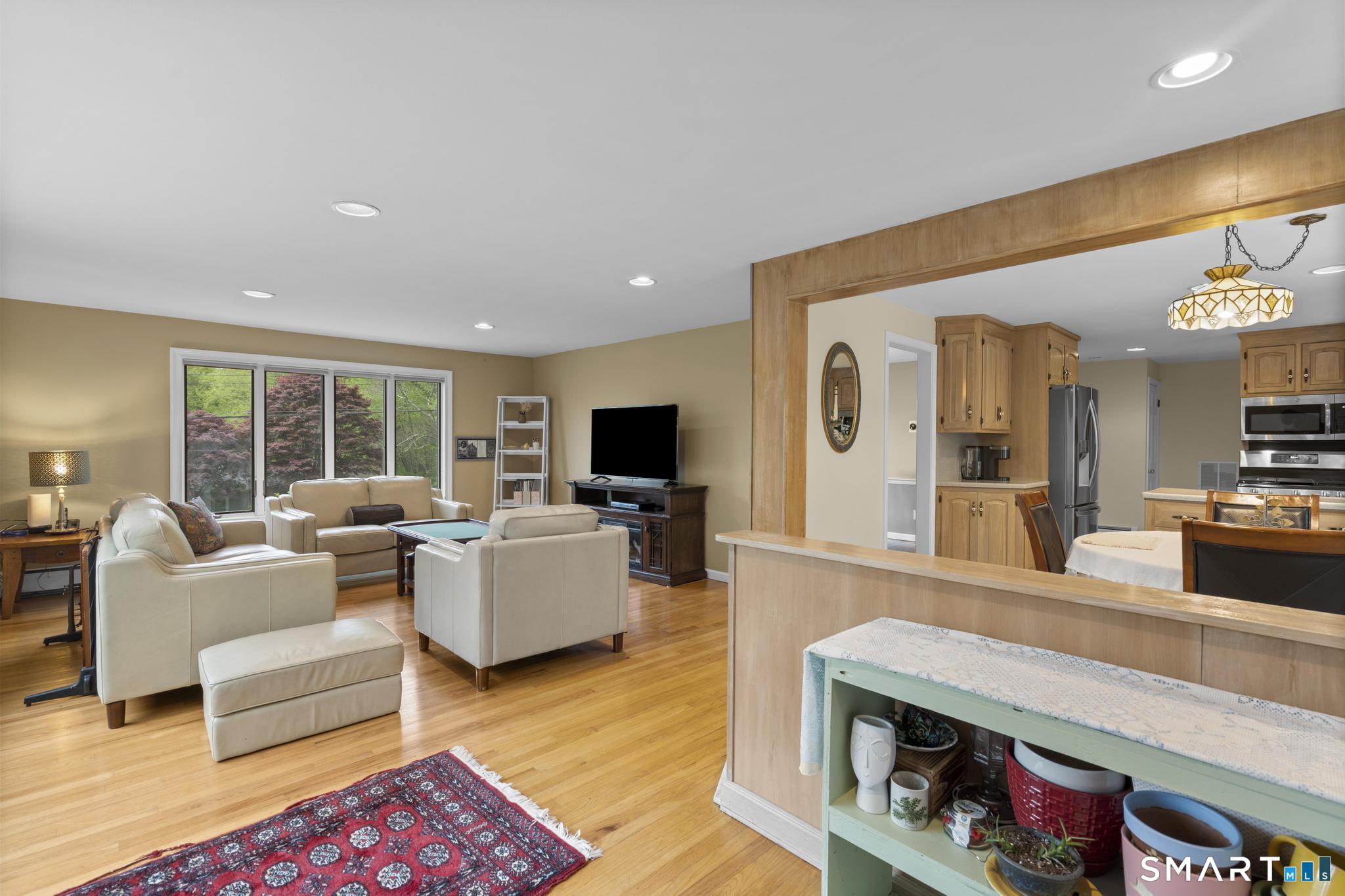 832 Quarter Mile Road Orange, CT 06477 - Photo 24 of 39 a living room with furniture and a flat screen tv